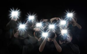 Group of photographers with cameras on black background. Paparazzi
