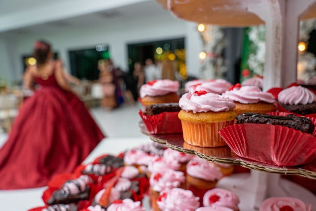 lots of chocolate brownies and strawberry vanilla cupcakes or cup cakes at a quinceañera party 