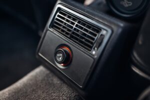 Cigarette lighter socket in old 1990s car interior