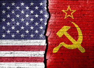 cold war. Flag of the Soviet Union (1922-1991). The American flag (50 stars) is repeatedly exposed in cracks. Double exposure of conceptual images of the United States and the Soviet Union.