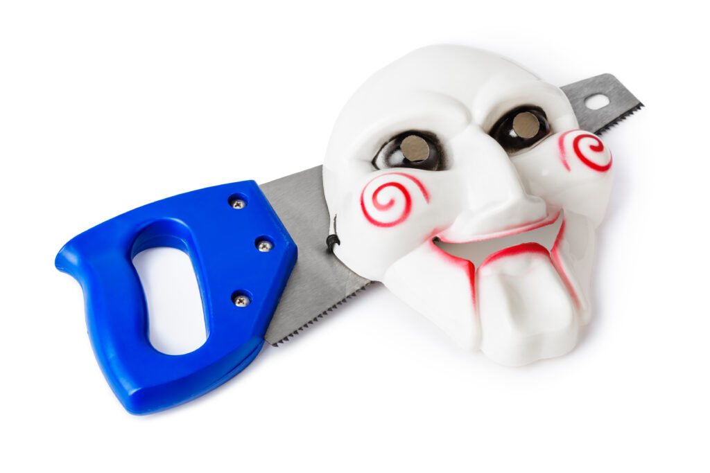 Maniac mask and saw isolated on white background