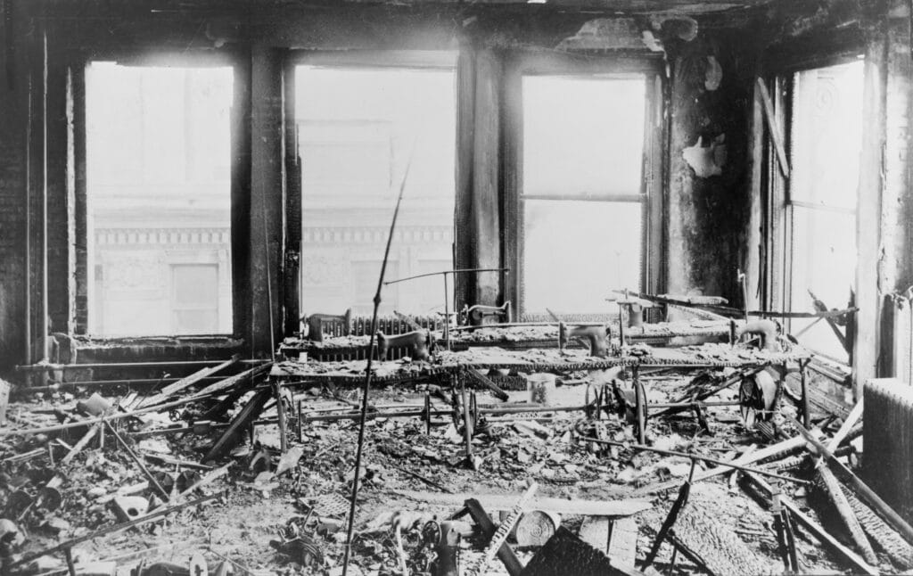 Triangle Shirtwaist Factory interior, destroyed sewing machines, gutted by a fire that killed 146 on March 25, 1911. Managers locked fire exits to prevent thefts, trapping immigrant women workers.