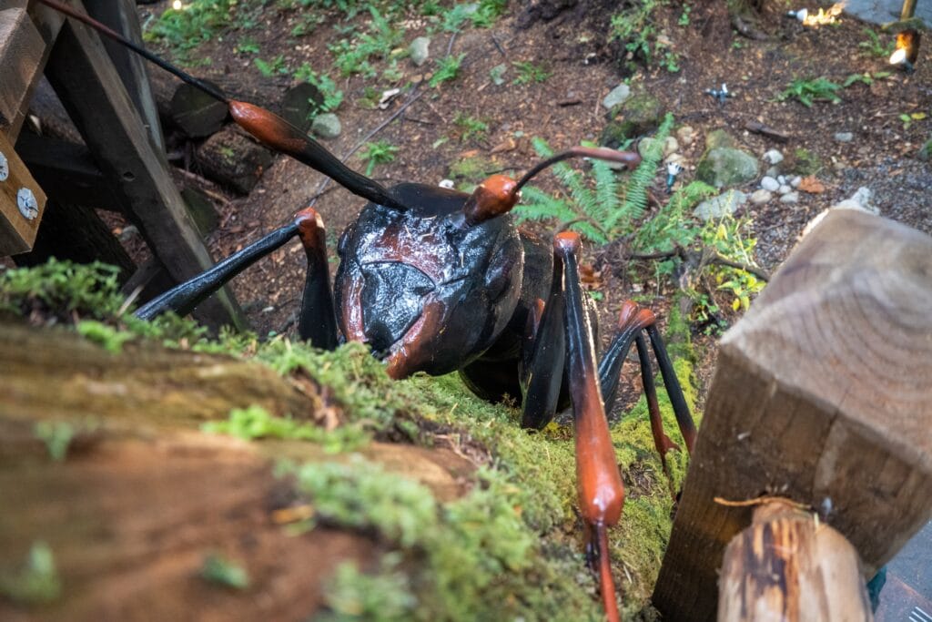 Giant ant model climbing a tree, used for decoration in a tourist area in the rain forest