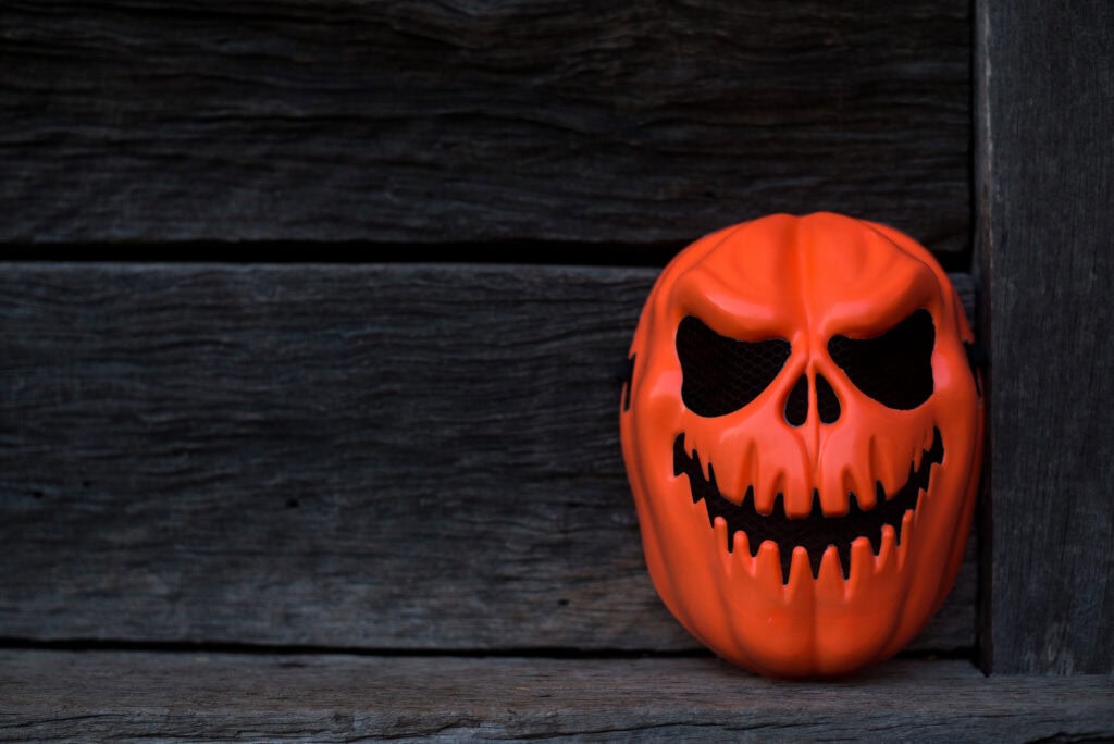 Orange Ghost Mask placed in an old house in the dark, Focus on the mask, Copy-space