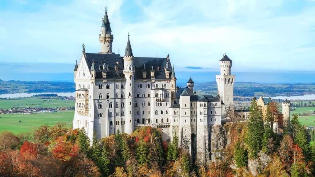 Neuschwanstein Castle in Bavaria Germany surrounded by autumn mountains a fairytale fortress with romantic medieval architecture a famous historic landmark one of the most beautiful castles in Europe