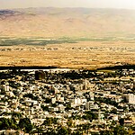 Which city's walls fell after the Israelites marched around it?