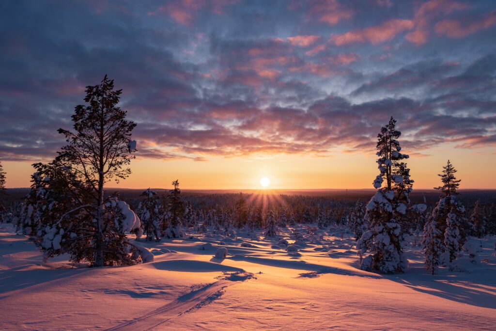 Hiking to the summit of Mount Kiilopää during a spectacular arctic sunset in Finnish Lapland.