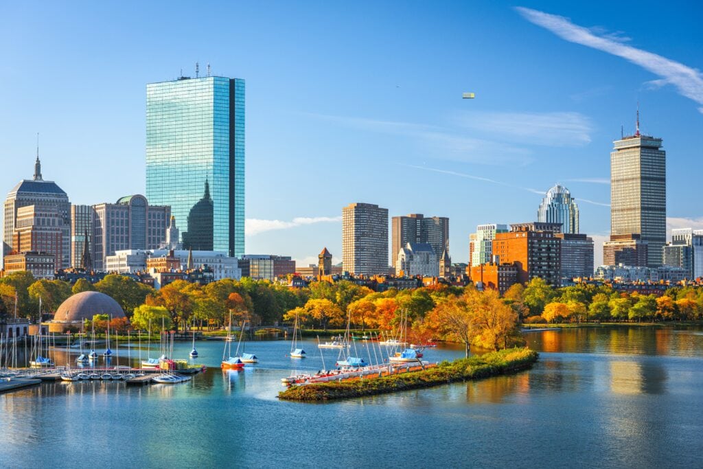 Boston, Massachusetts, USA skyline on the Charles River in the morning with early autumn foliage.