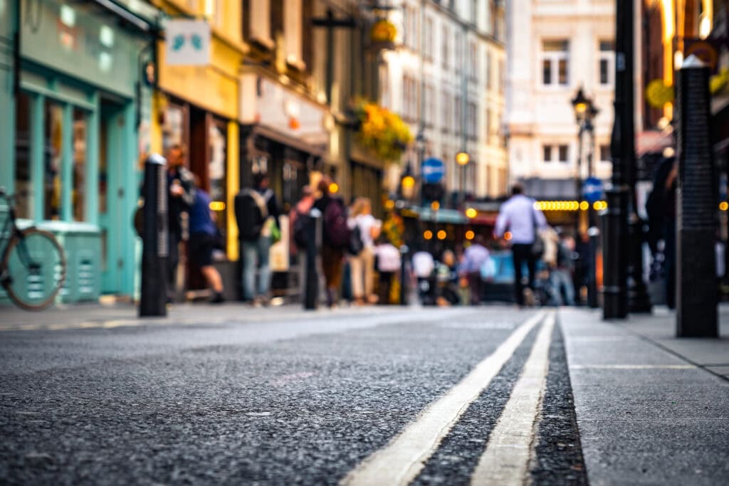 Close focused low street view of London's West End shops and people