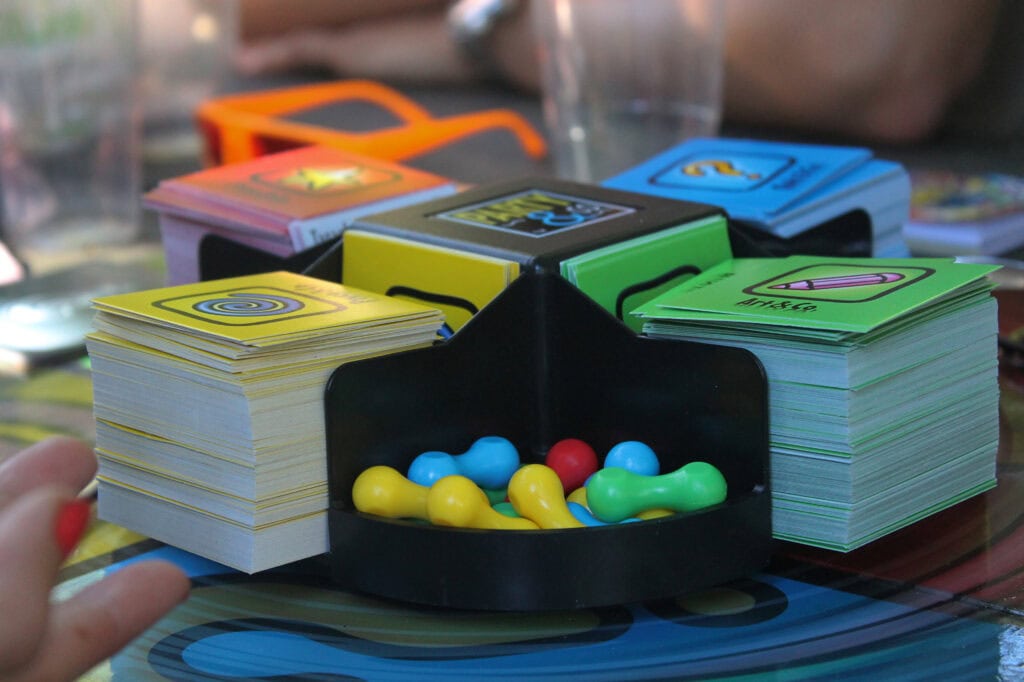 
Close-up of Pictionary, a board game with cards and playing chips of colors.