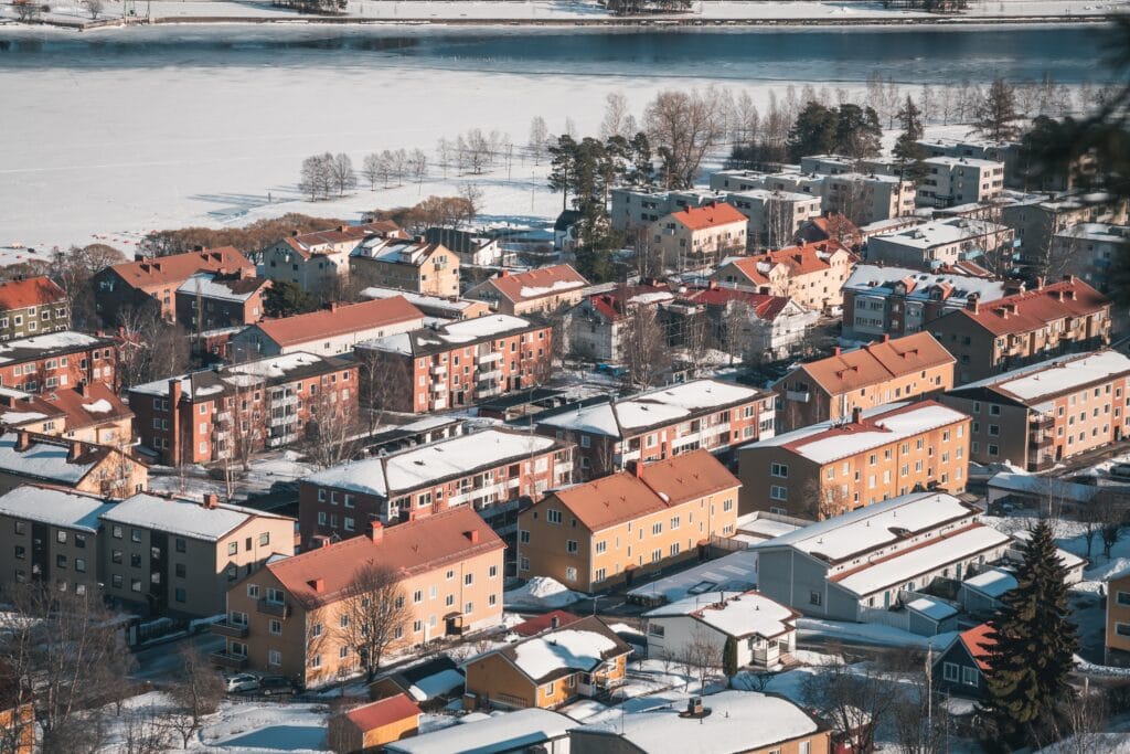 Östersund (Sweden Lapland) in March. Aerial view of cityscape panorama with snow and frozen lake Storsjön.