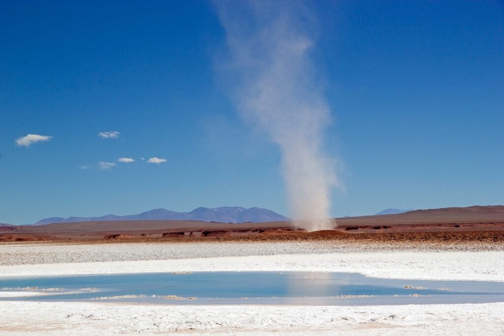 Tornado at the Ojos de Mar close the town of Tolar Grande in Puna, Argentina. Ojos de Mar is a group of small water bodies characterized by a blue colour in white salty desert landscape