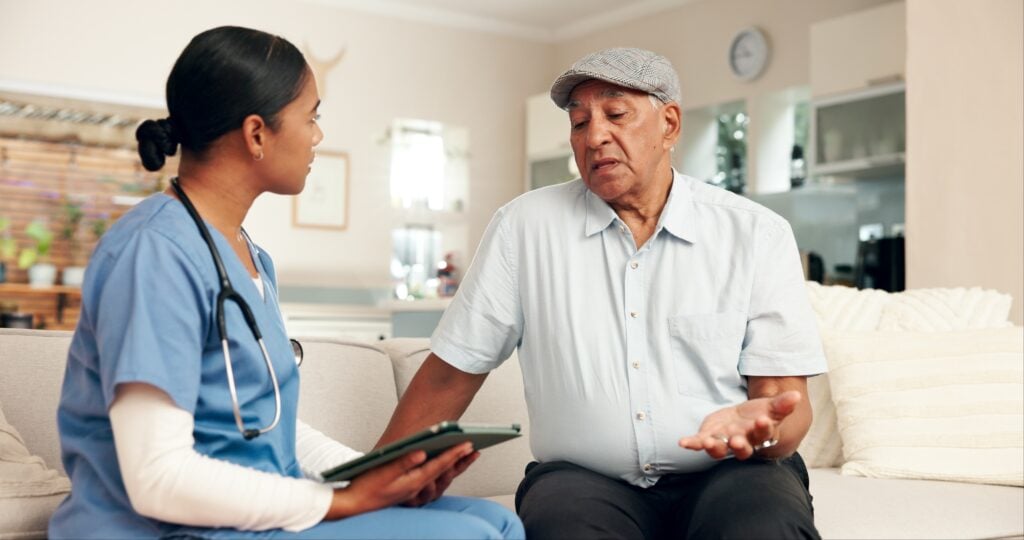 Retired man discussing healthcare with a medical professional