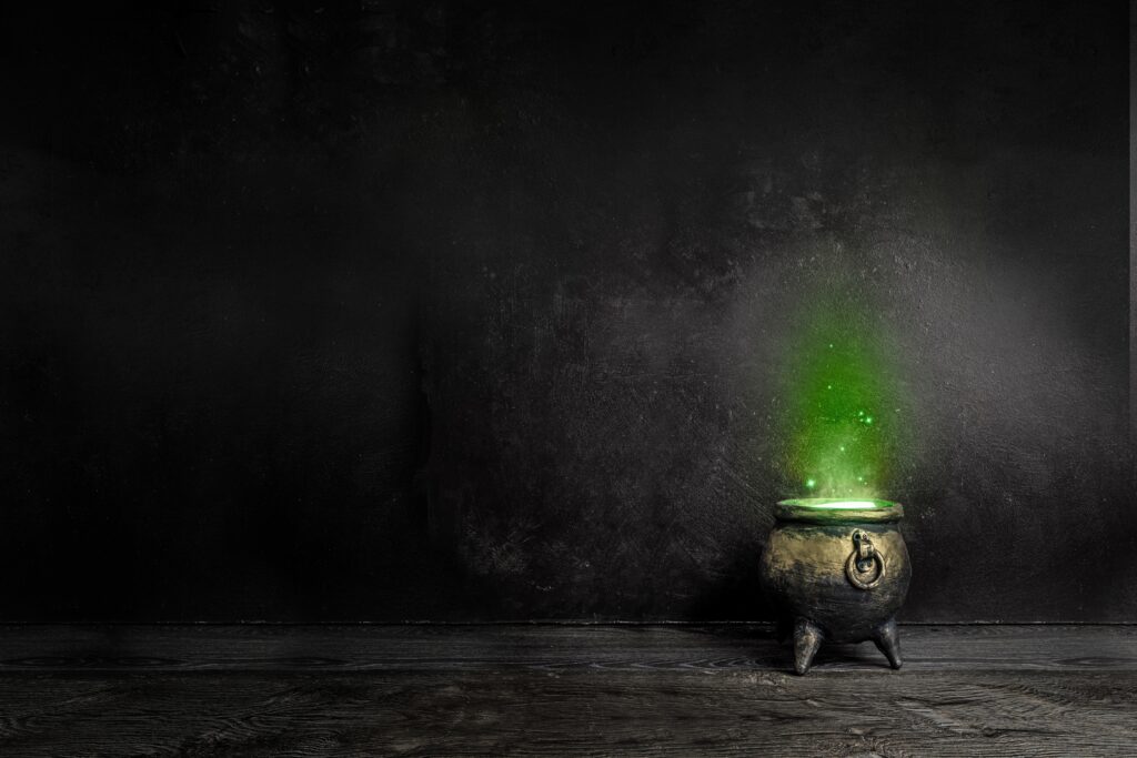 Dark witch cauldron with a magi.c witch's potion in a dark room