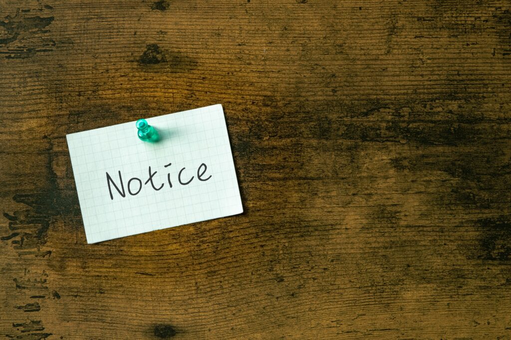 There is a piece of paper with the word Notice. It is as an eye-catching image.