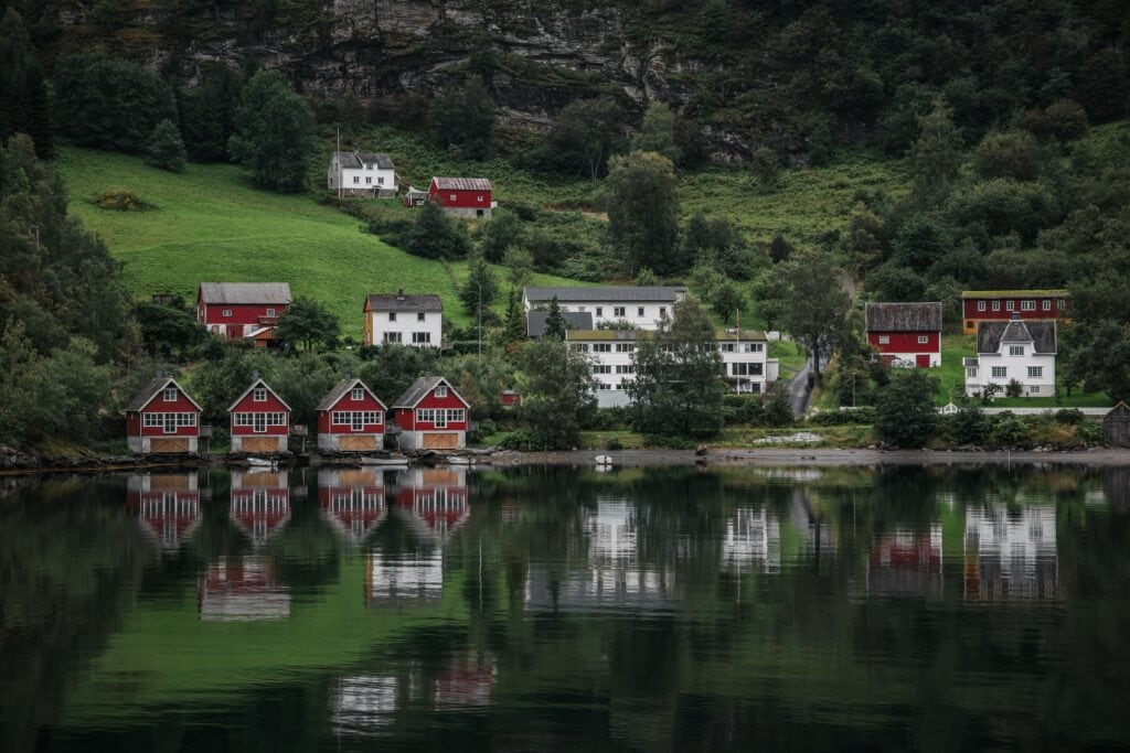 Traditional Norwegian houses situated on the water edges in Flam, Aurland at the end of the Aurlandsfjord, a branch of Sognefjorden