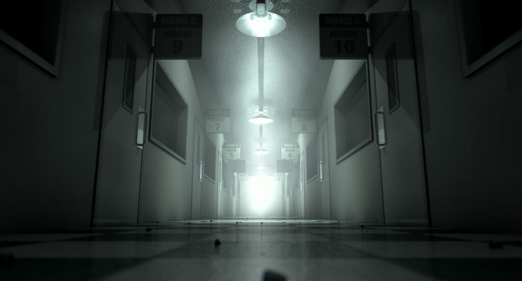 An eerie haunted look down the dimly lit passage of a dilapidated mental asylum with rooms and signs