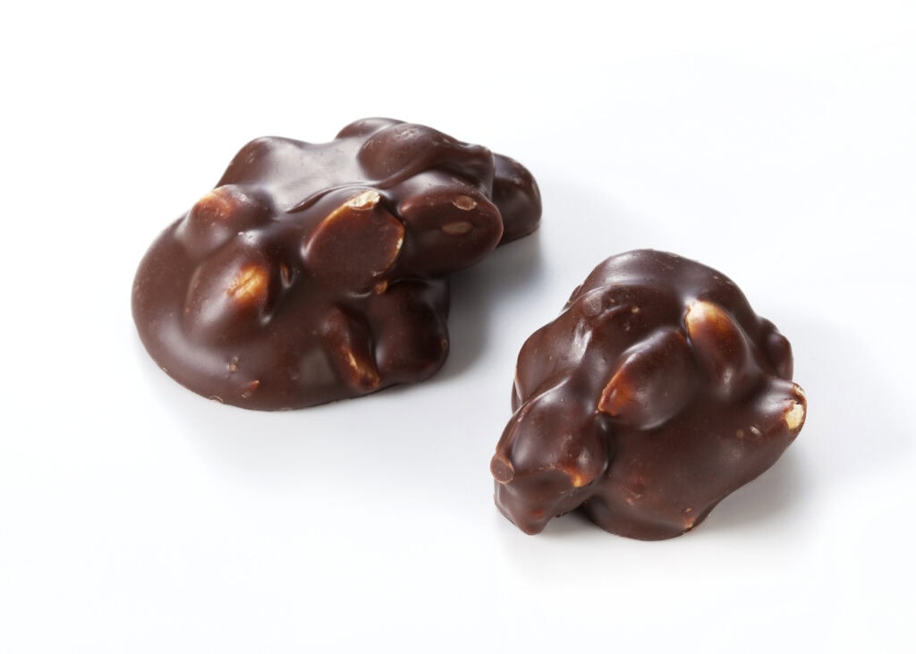 Chocolate pieces with nuts on a white background